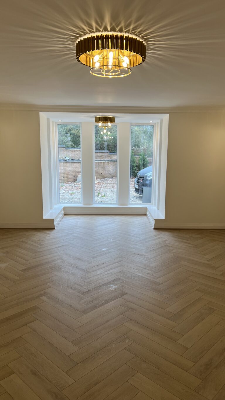 Lignum Core Linen Oak herringbone SPC flooring fitted in a Walsall lounge with a bay window