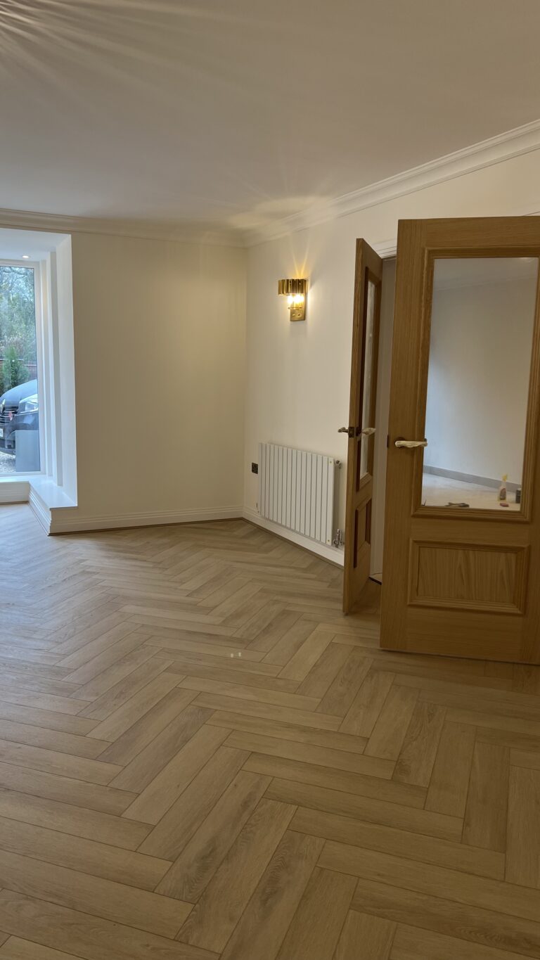 Lignum Core Linen Oak herringbone SPC flooring fitted around the lounge doorway in Walsall