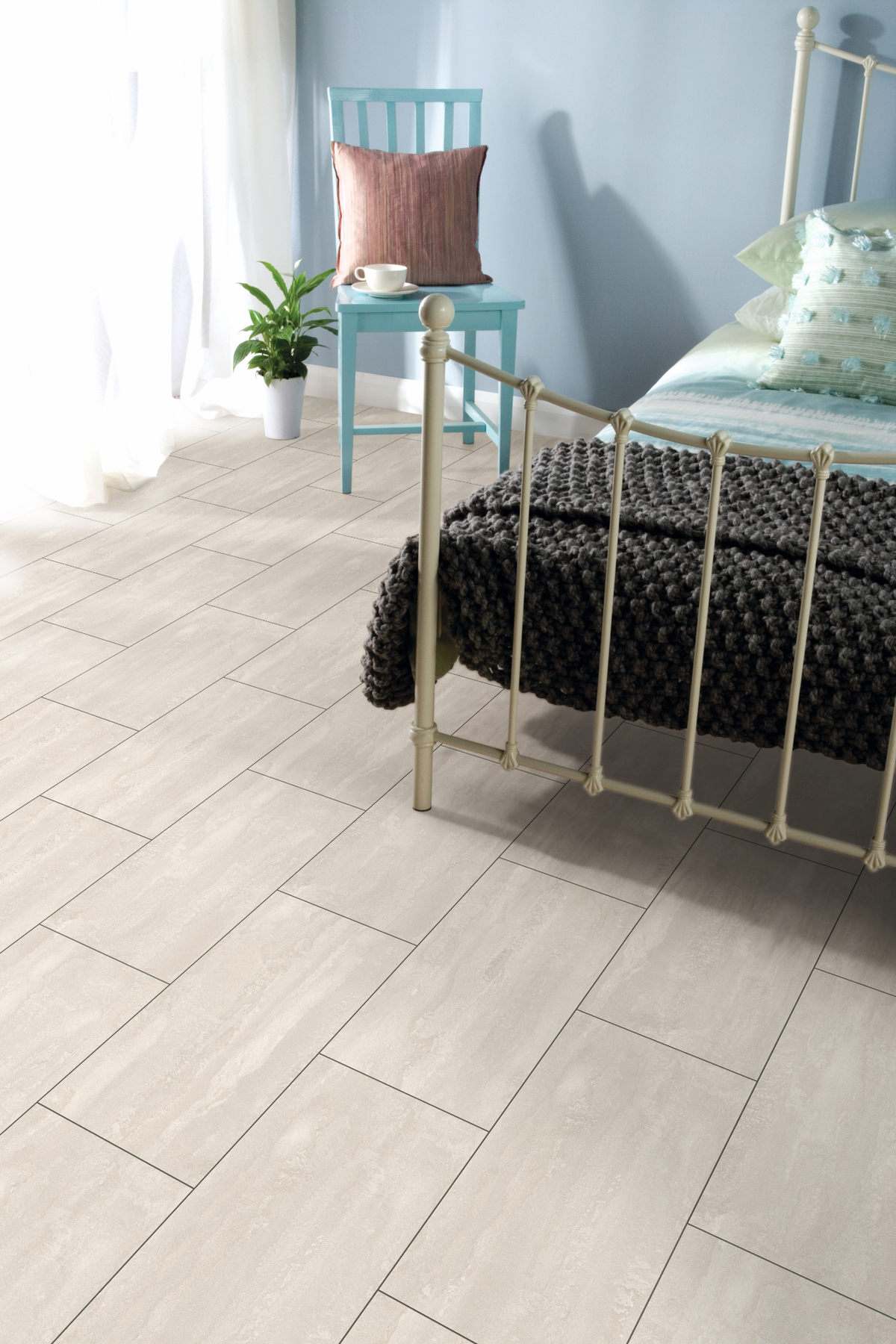 Organic Classic Ice Flow room scene Organic Classic Ice Flow 8mm cream tile-effect laminate flooring in a bedroom